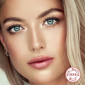 Close-up of S925 sterling silver nose ring and earring on model with 925 silver seal
