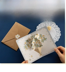 Detailed view of 3D pop-up flower card with daisies and brown kraft envelope