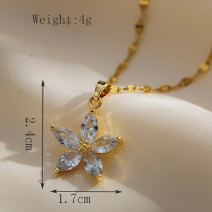 Macro view of gold flower pendant necklace with clear marquise cut gemstones