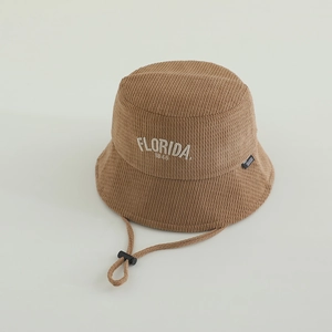 Detail of tan corduroy kids bucket hat featuring FLORIDA embroidery and adjustable strap