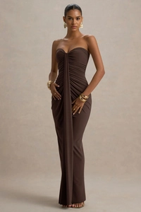 Detail of ruched texture and draped fabric on a slim fit strapless brown maxi dress