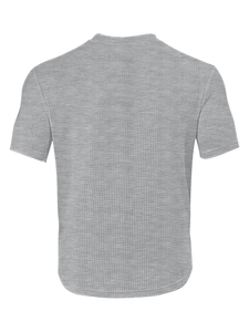 Macro view of grey waffle knit fabric texture and premium honeycomb weave on a men's t-shirt