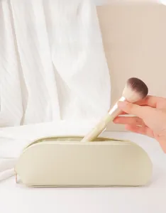 Dettaglio di un astuccio per pennelli in pelle PU beige con cerniera e pennello morbido