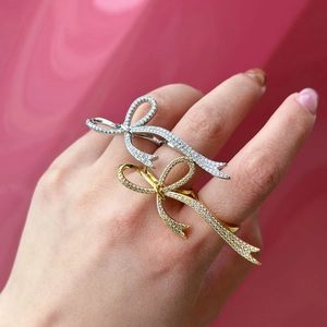 Elegant adjustable bow rings in gold and silver finish with sparkling crystal stones