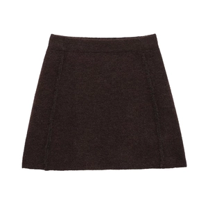 Close-up of deep brown knit mini skirt showing high-quality wool texture and A-line cut