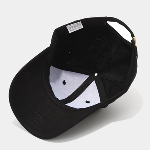 Internal view of black cotton baseball cap showing 6-panel structure and metal buckle