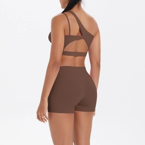 Detail of chocolate yoga set with asymmetrical shoulder strap and high waist shorts