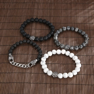 Detail view of lion head bead bracelets in volcanic stone and tiger eye on a bamboo mat
