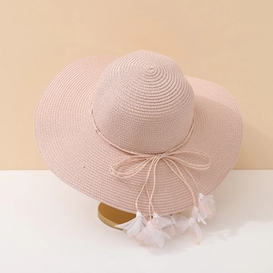 Pink wide brim straw hat with bow and floral tassels for summer beach vacations