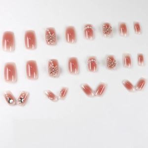 Pink blush gradient press-on nails with 3D bows, pearls and butterfly rhinestones