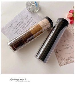 Close-up of high-elastic seamless hair ties in coffee and black sets inside clear tubes