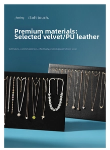 Detail of jewelry display board with gold hooks featuring velvet and PU leather texture