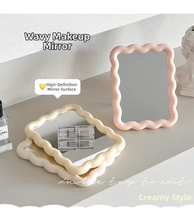 Detail of wavy frame mirrors in pink, beige, and white colors on a vanity desk