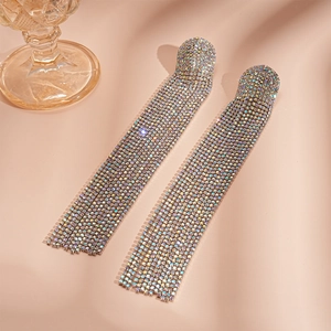 Macro shot of silver-tone tassel earrings featuring shimmering AB rhinestones and long fringe