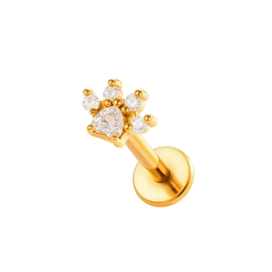 Piercing doré en forme de patte avec zircons clairs sur un fond blanc épuré