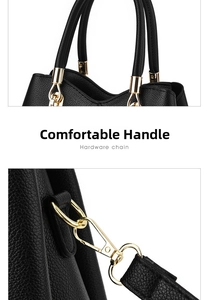 Détail d'un sac à main noir en cuir grainé avec anneaux dorés et accessoires métalliques