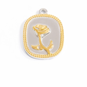 Detail of oval two-tone metal pendant with 18K gold relief rose and beaded border