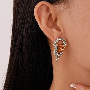Exaggerated golden snake stud earring with amber triangle stone and micro-pave diamonds