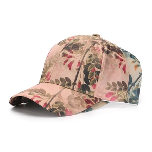 Detail of floral print baseball cap featuring pink fabric and breathable mesh panels