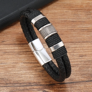 Detail of double-layer black braided leather bracelet with silver magnetic buckle
