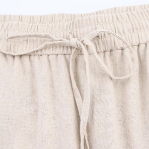 Detailed macro view of the beige linen-blend trousers' elastic waist and drawstring