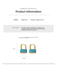 Detailed view of gold oval lock earrings with micro-pave blue cubic zirconia stones