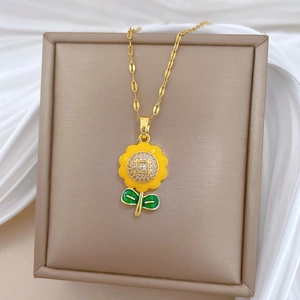Detailed view of sunflower pendant with yellow enamel petals and zircon on jewelry box