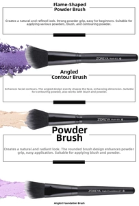 Close-up of professional makeup brushes with matte black handles and dense synthetic bristles