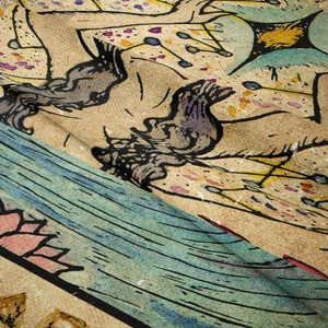 Macro view of printed tapestry showing ginger yellow fabric and artistic floral patterns