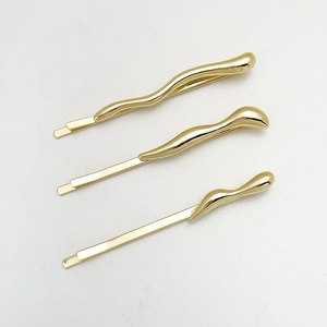 Three-piece set of wave-shaped golden alloy hair clips with polished metallic surface
