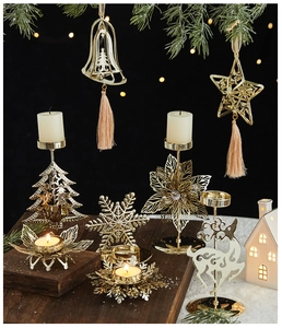 Detail of golden metal Christmas candle holder with snowflake and reindeer patterns