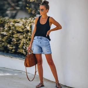 Outdoor look featuring light wash denim shorts with frayed hems and a black tank top