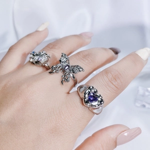 Minimalist silver butterfly ring and purple heart gemstone ring set on hand