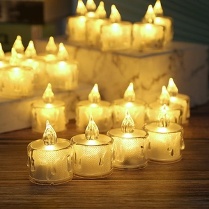 Detail of white LED tea light candles with realistic melted wax drip effect and warm yellow glow