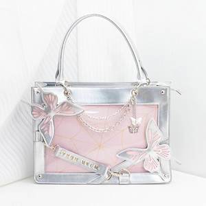 Close-up of metallic silver tote bag with pink butterfly appliques and metal chains