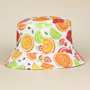 Close-up of a summer bucket hat with vibrant fruit prints like orange and strawberry
