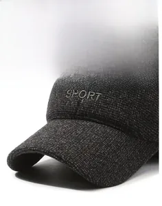 Macro view of dark grey textured fabric and SPORT embroidery on a winter baseball cap