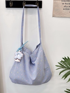 Blue and white checkered fabric tote bag with a white flower plush charm accessory