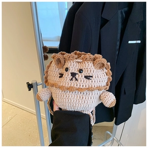 Detailed knit texture of handmade lion crochet crossbody bag with 3D mane and soft yarn