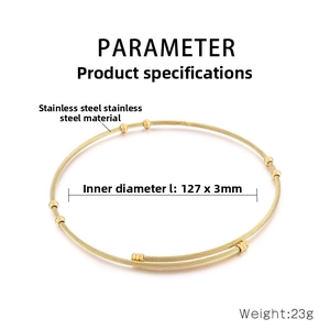 Detail of 127x3mm golden stainless steel wire torque with spherical bead accents