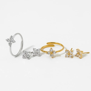 Elegant clover jewelry set featuring silver and gold zircon earrings and adjustable rings