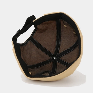 Beige cotton docker cap showing internal six-panel structure and adjustable buckle