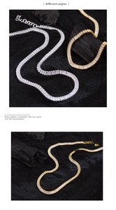 Detailed macro view of rectangular cut zircon necklace with silver and gold finishes