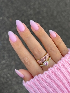 Close-up of pink gemstone leaf ring and heart crystal ring with gradient manicure