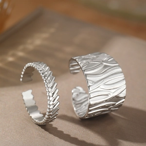 Set of two silver stainless steel open rings with irregular wavy and textured surface