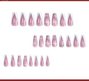 Detailed view of long coffin nails with white snowflakes and rhinestones on pink base