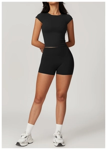 Close-up of black tight-fit yoga set with high-waisted shorts and breathable fabric