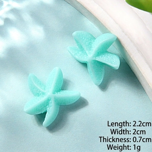 Macro shot of mint green resin starfish charms with texture and size specifications
