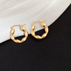 Minimalist twisted gold chunky hoop earrings with textured metallic finish for women