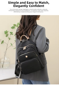 Dettaglio dello zaino nero in nylon capiente con tasche multiple e cerniere dorate